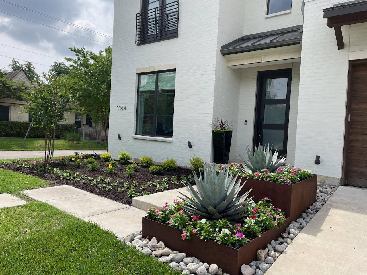 containers with succulents and in-ground bed