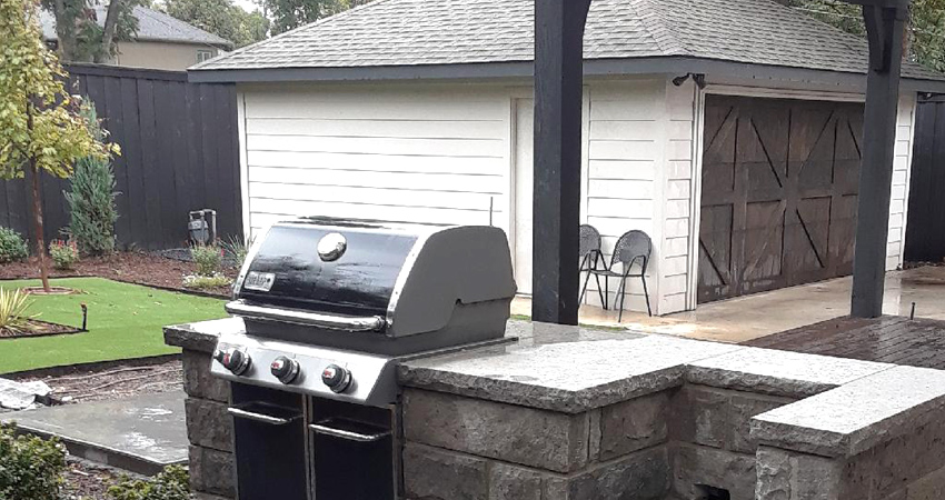 outdoor grill and garage in new landscape installation